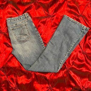 Best fit super stretch Guess bells in medium blue distressed denim, 31